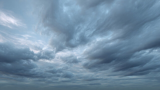 A dramatic sky filled with tumultuous, dark grey clouds and wisps of lighter formations, suggesting an impending storm or moody weather.