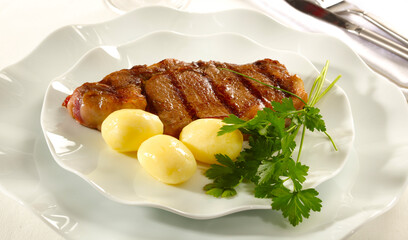 Grilled beef steak with boiled potatoes and parsley