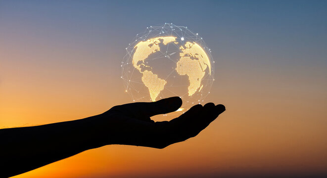 A silhouette of a hand holding a glowing, networked globe