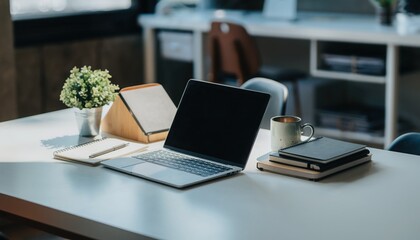 Workspace: Modern workspace features a laptop, digital tablet, coffee, notebook and plant. The scene creates the perfect setup for productivity, creativity, and focused work