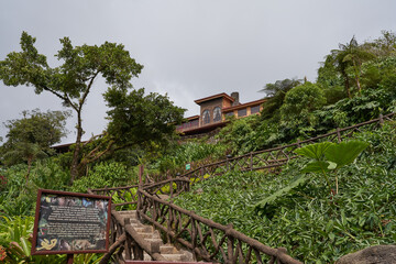 Vara Blanca, Costa Rica - November 14, 2024 - the La Paz Waterfall Gardens Nature Park - stone staircase with a unique wooden railing in a lush tropical garden
