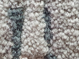 Carpet textile background with a soft woven texture in cream and green colors. Decorative interior fabric pattern