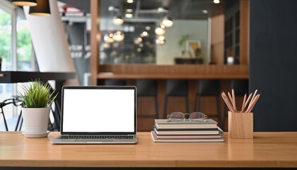 Workplace Still Life: A modern workspace with a laptop, plant, and office supplies. The image is a visual representation of a workspace and a modern design.