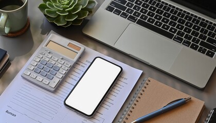 Digital Workspace: A modern workspace comes alive, showcasing a laptop, smartphone, calculator, notepad, pen, succulent plant, and a steaming mug, offering a snapshot of a productive environment.