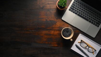 Workspace Harmony: A high-angle shot of a meticulously arranged workspace on a dark wooden desk, complete with a laptop, a steaming cup of coffee, and a notepad and eyeglasses.