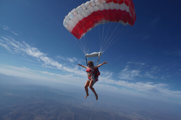 Woman jumping with a parachute
