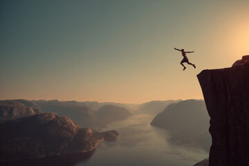 Man jumping into the weater from a very high spot 