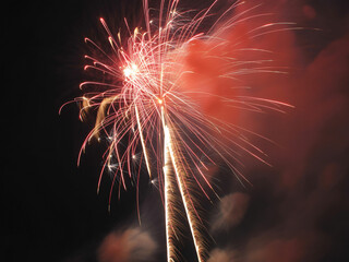 Stunning fireworks display illuminating the night sky with vibrant trails and festive celebration spirit