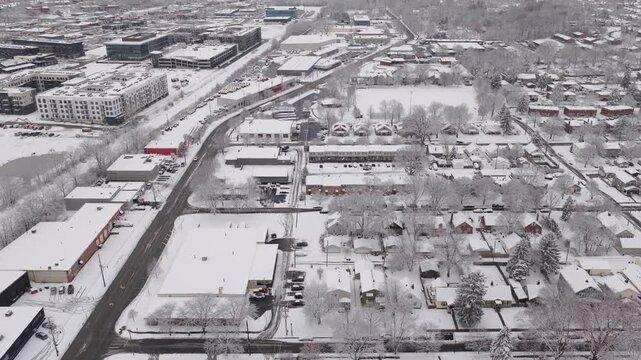 Upper class American suburban suburb near Columbus, Ohio in middle class neighborhood with homes, townhouses, houses, streets, and roads during a wintry and snowy winter storm with cold snow and ice