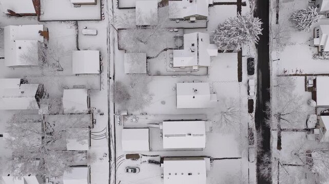 Upper class American suburban suburb near Columbus, Ohio in middle class neighborhood with homes, townhouses, houses, streets, and roads during a wintry and snowy winter storm with cold snow and ice