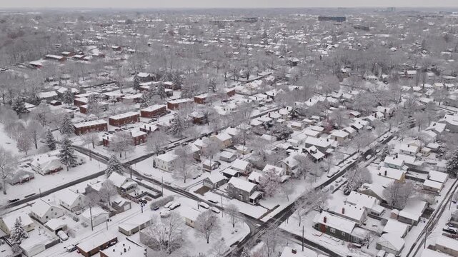 Upper class American suburban suburb near Columbus, Ohio in middle class neighborhood with homes, townhouses, houses, streets, and roads during a wintry and snowy winter storm with cold snow and ice