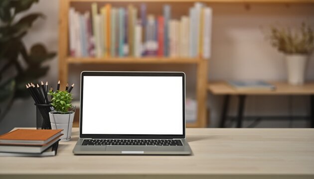 Digital Canvas: A modern laptop on a wooden desk, offering a blank screen ready for creative work or presenting ideas, set against the backdrop of books and greenery. - Powered by Adobe