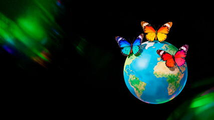 Three different butterflies sit on earth globe on black background, Zero Discrimination Day, 1 March annual event, horizontal banner, free space for text, copy space