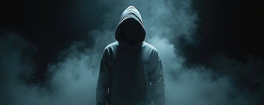 Anonymous figure in hoodie stands amidst smoke on black background. Man in darkness represents mystery crime danger. Concept illustration of digital security threat or cybercrime attack. - Powered by Adobe