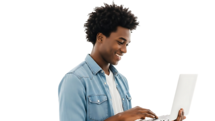 Young black man smiling while working on a laptop computer