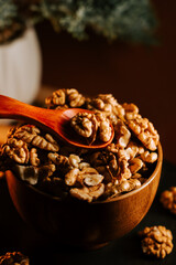 Freshly peeled walnuts in a wooden bowl with a spoon ready for serving