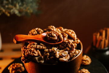 Peeled walnuts arranged in a wooden bowl with a wooden spoon ready for serving