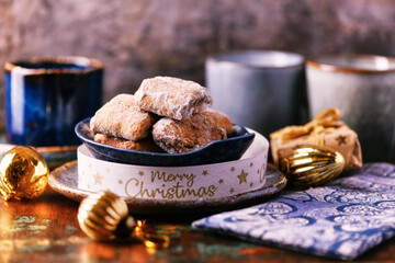 Traditional christmas cookies in a bowl on a rustic wooden background. Soft focus.	