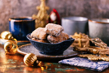 Traditional christmas cookies in a bowl on a rustic wooden background. Soft focus.	