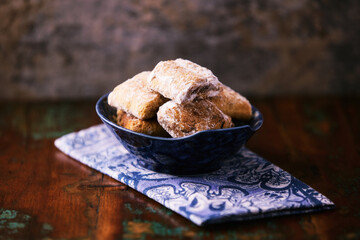 Traditional christmas cookies in a bowl on a rustic wooden background. Soft focus.	