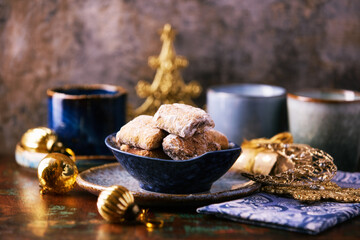 Traditional christmas cookies in a bowl on a rustic wooden background. Soft focus.	