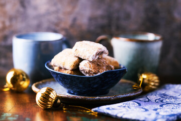 Traditional christmas cookies in a bowl on a rustic wooden background. Soft focus.	