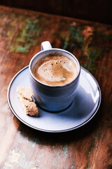 Cup of coffee on rustic wooden background. Soft focus. Copy space	