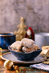 Traditional christmas cookies in a bowl on a rustic wooden background. Soft focus.	