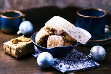 Traditional christmas cookies in a bowl on a rustic wooden background. Soft focus.	
