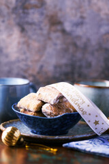 Traditional christmas cookies in a bowl on a rustic wooden background. Soft focus.	