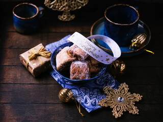 Traditional christmas cookies in a bowl on a rustic wooden background. Soft focus.	