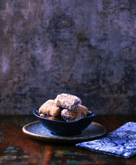 Traditional christmas cookies in a bowl on a rustic wooden background. Soft focus.	