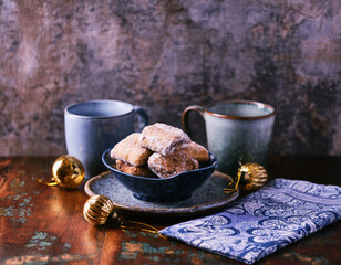Traditional christmas cookies in a bowl on a rustic wooden background. Soft focus.	