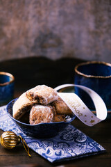 Traditional christmas cookies in a bowl on a rustic wooden background. Soft focus.	