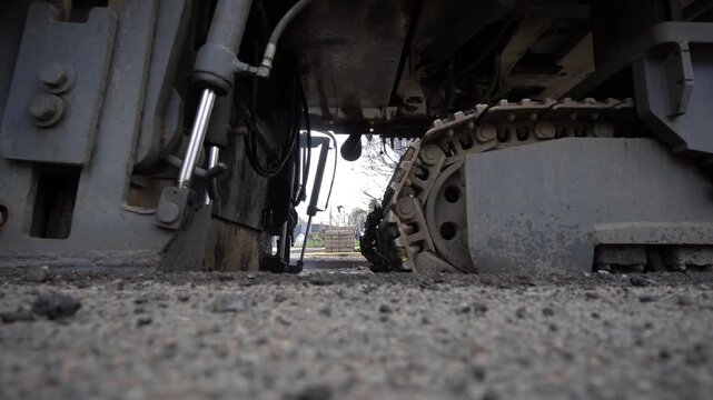 Machine for demolishing asphalt road surfaces