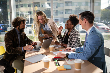 Diverse business team collaborating and discussing during meeting