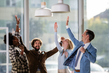Diverse business team celebrating success winning together