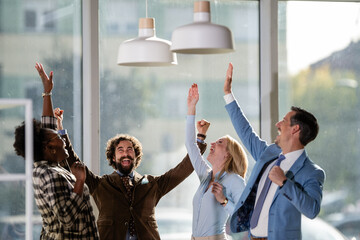 Happy business team celebrating success at office
