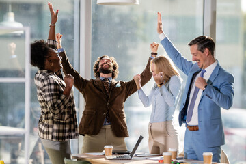Diverse business team celebrating success and achievement in office
