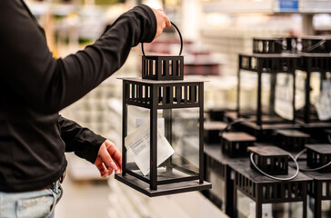 Woman Picking Decorative Candle Lantern At Store