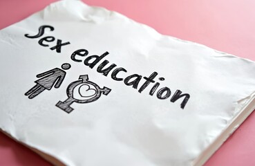Text Sex Education with gender symbols on white paper. Includes female male and transgender icons. Information on relationships intimacy and health topics.