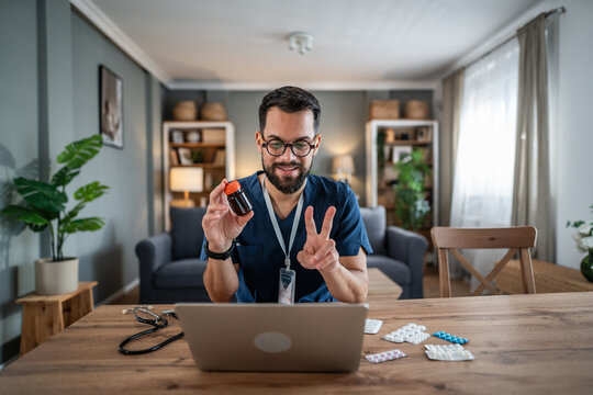 Doctor holding medicine bottle during online consultation