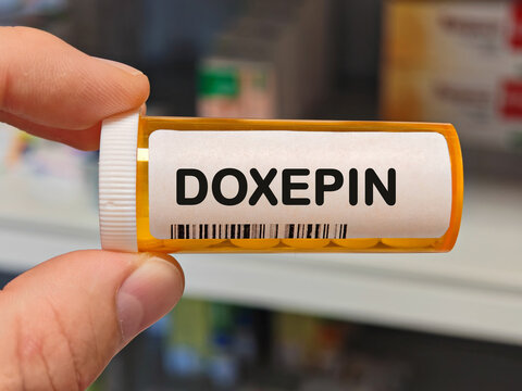Box of DOXEPIN tablets on a hospital pharmacy table used to treat depression anxiety and insomnia a tricyclic antidepressant.
