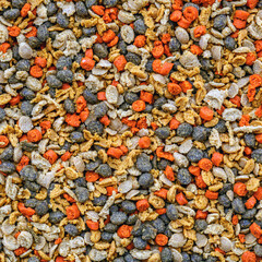 Aquarium fish fodder closeup.Food multicolored for animals and aquarium fish in grits.Top view