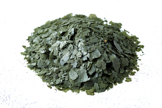 Aquarium fish fodder closeup.Pile of flakes and granules for feeding tropical aquarium fish,Side view.Aquarium