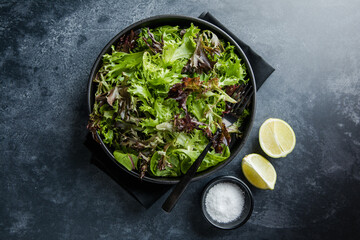 Fresh leaves salad plate. Healthy food. Diet dinner or lunch menu. Salad plate on table. Flat lay. View from above