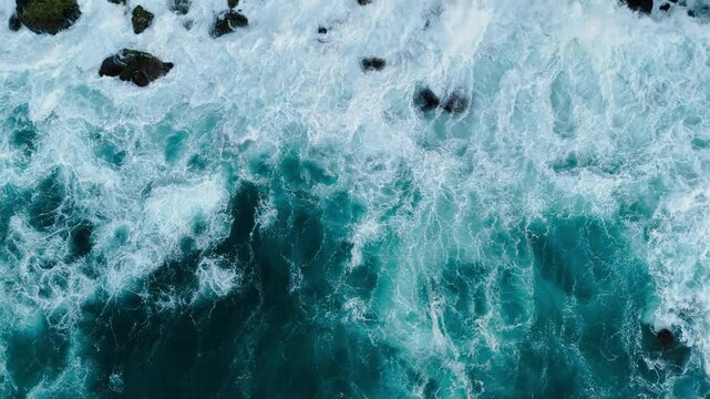 Powerful stormy sea waves in top-down drone shot perspective. Crashing wave Atlantic ocean with foamy white texture