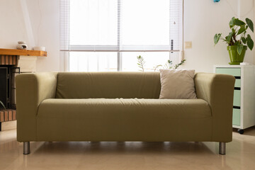 Green sofa bringing comfort to a bright living room