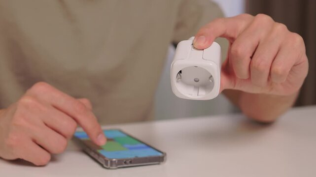 Smart device setup, User demonstrates smart socket connection, Closeup of smart plug pairing process, Installation and control of European style smart socket device