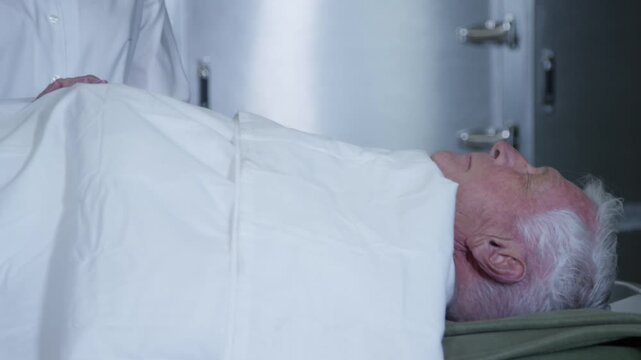 A corpse on a gurney in a hospital morgue